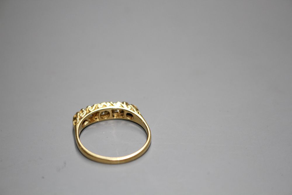 A modern 18ct gold and graduated five stone diamond half hoop ring,